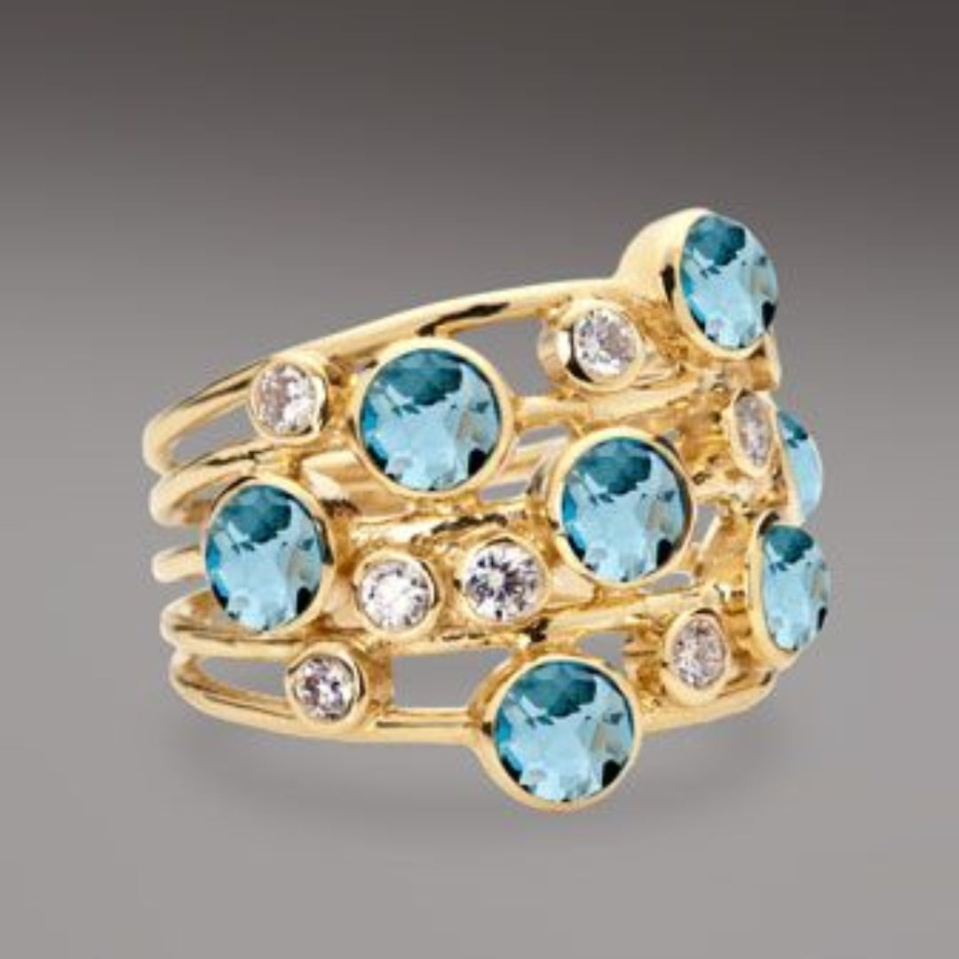 Vintage gold ring with many blue and white zirconia stones