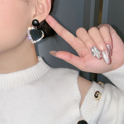 Gold earrings with dark heart