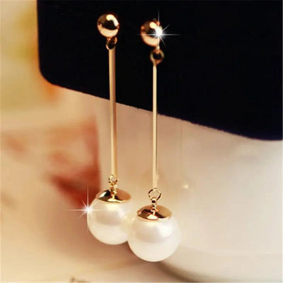 Luxurious dangling earrings with special hand-placed pearls