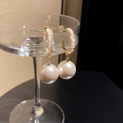 Luxury earrings with a stylish pearl and zirconia