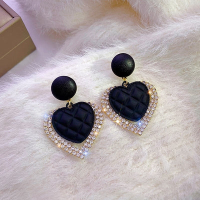 Gold earrings with dark heart