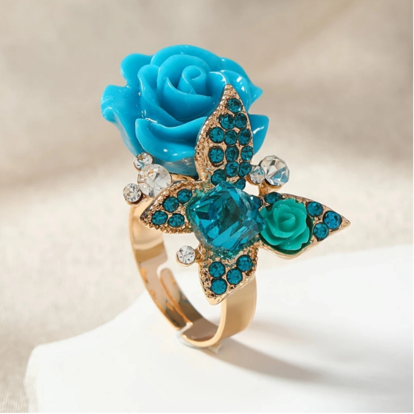 Gold ring with blue flower and butterfly